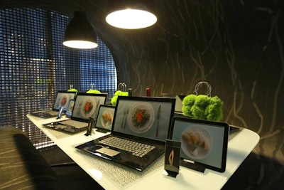 At the table from Shaw Contract/Vortex Enterprises, designed by Box Studios, laptops and tablets showcasing images of food replaced traditional place settings.