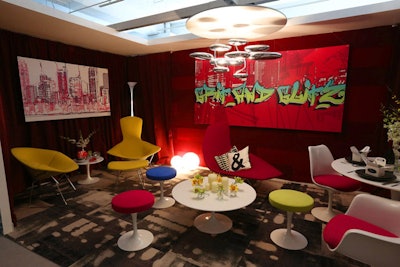 Knoll/Spinnybeck Leather's vignette, designed by Solomon Cordwell Buenz Interior, had the look of a city apartment. Brightly colored lounge furniture filled the space, as well as a graffiti-style painting that spelled out 'Grit and Glitz.'