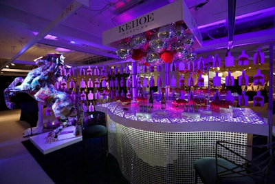 Kehoe Designs' eye-catching booth had an oversize stallion statue, a curvy, mirrored bar, disco balls, and color-changing light.