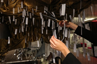 Project Interior's table was one of the most interactive. Guests grabbed a pair of large golden scissors to snip affirmative statements written on small pieces of paper from an overhead canopy. The statements included phrases such as 'Act With Love' and the Matisse quotation 'Creativity Takes Courage.'