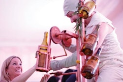 Chicago-based Redmoon Theater’s annual benefit in March had a performer topping off guests’ glasses with the company’s “Wine Bike,” which features a spinning chandelier of wine glasses and a series of gears that pour bottles of wine.