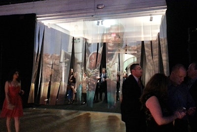 Rather than creating exhibitions of printed graphics and photographs, Charity:Water and the production team at Empire Entertainment incorporated artwork into the decor. This included having an oversize image printed onto the draping that covered the entrance to the 69th Regiment Armory's drill hall.