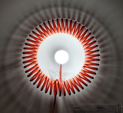 Latent Design's 'Extension' wreath was made from a laser-cut acrylic sheet, an orange extension cord, and a light.