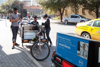 Pedicabs to carry attendees to and from the convention center included advertising about Dell products and services.