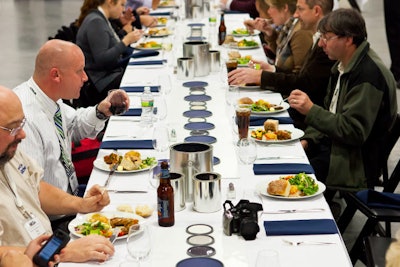 Employees sat down to dinner at table decked with paint can lids.