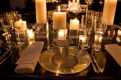 A mix of round and rectangular clear Lucite tables formed the dinner setup in the atrium. The sleek look was matched by clear chargers and ghost chairs; clusters of pillar candles replaced flowers as centerpieces.