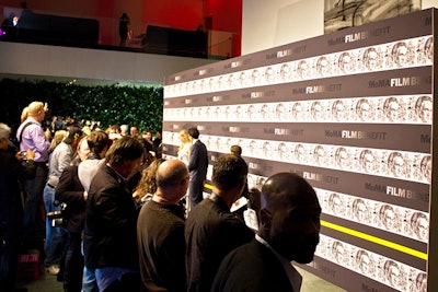 Instead of the typical step-and-repeat, the organizers opted to integrate a commissioned sketch into the backdrop for the celebrity arrivals area, placing the artwork in rows to emulate a film strip.