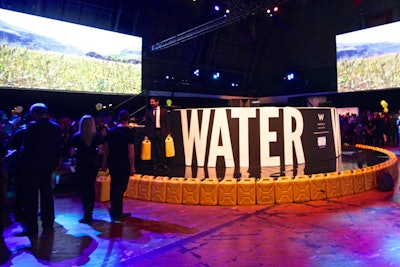 A circular stage was a strategic component to the gala's revised format, putting the night's hosts and live auction in the center of the space. The round platform, which was 20 feet in diameter and raised six feet off the ground, also gave Charity:Ball's signature activity—the 'waterwalk'—a central spot at the event. For every guest that walked the catwalk carrying two Jerry cans, sponsors W Hotels and Toms each donated $250 to water projects in India.