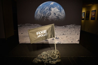 Axe turned the Cullman Hall of the Universe into its secret space headquarters for the launch event, placing signage and a moon-landing-inspired photo op area up front. To further play up the space academy concept, the production team created two oversize, illuminated metal detectors, which formed a checkpoint-style entrance to the main space.