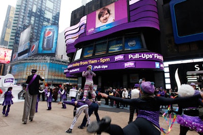 Every time someone flushed the oversize toilet, a team of upbeat cheerleaders, stilt walkers, and jugglers staged a celebratory performance. The nearby ABC SuperSign displayed branded Pull-Ups graphics.