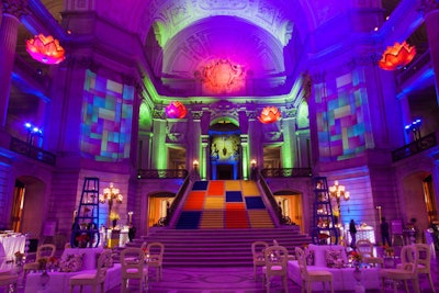 Colorful, modern lighting projections consumed City Hall's historic domed rotunda. Around 855 patrons spent between $1,000 and $3,500 per dinner ticket; grand benefactors dined in the ornate rotunda, while benefactors and patrons supped in the North Light Court.
