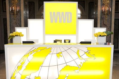 Fairchild Fashion Media's Kristen Wildman worked with XA to create the modern design of the WWD C.E.O. Summit inside the Plaza. A color scheme of bright yellow against white was used throughout, including in the registration desk, giving the decor a clean, uniform look.