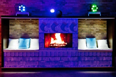 Capital C's creative director of live events, Mary Pallattella, created booths against the wall of the dance floor space for the company's holiday party. A video fireplace centered the booths.