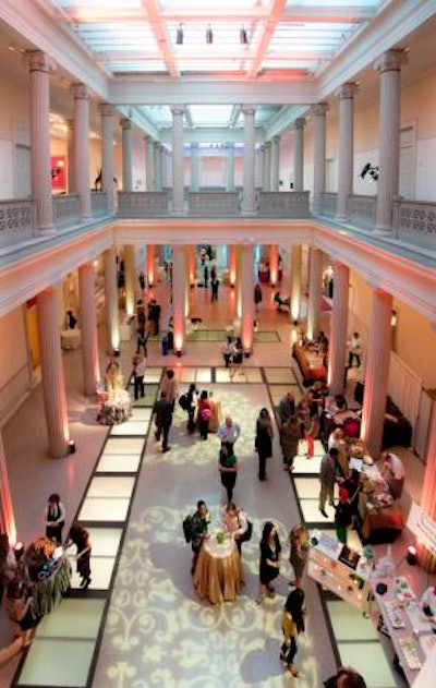 Caterers and vendors set up tables around the perimeter of the space to showcase products for holiday parties.