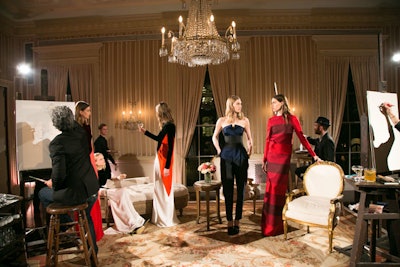 To realize the artists' drawing room in the venue's ballroom, AO Production built a 12- by 16-foot wooden stage that was elevated eight inches off the floor, wrapped in natural muslin, and covered with an antique carpet. Throughout the night, three artists sketched models clad in Stella McCartney's evening dresses as guests seemingly became part of the intimate event.