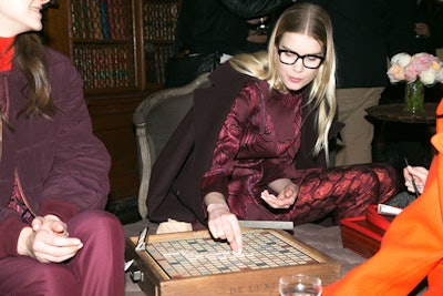 As is customary at Stella McCartney presentations, models are encouraged to interact with guests and the surrounding environment. In the library, models played Scrabble while clad in McCartney's designs, including a pair of glasses from her new sustainable eyewear collection.
