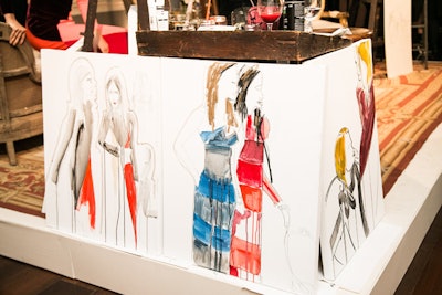 Artist illustrations of models clad in the collection were documented in real time and displayed for attendees.