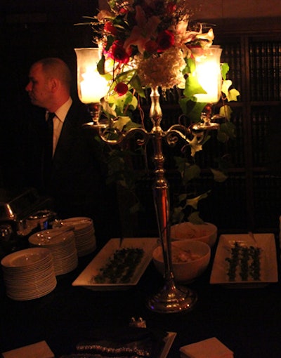 Sculptural floral arrangements from McNabb Roick decorated the tops of candelabra, giving the tabletops a romantic feel.