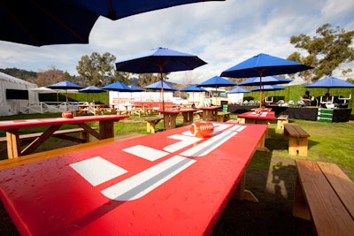 On the outdoor patio, Russell Harris Event Group used blue umbrellas to contrast with the red ESPN-branded picnic tables. Football-shaped bowls containing candy and nuts served as the tabletop centerpieces.