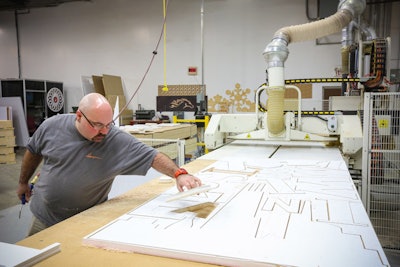 Hargrove uses a heavy-duty router to cut thousands of elements needed for the inauguration including cut-out letters for the floats.