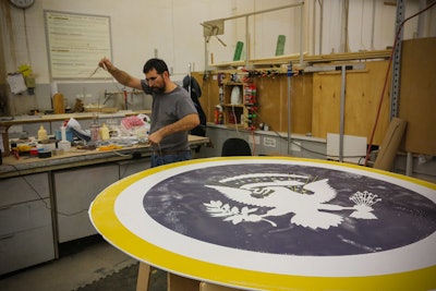 Hargrove produces hundreds of presidential and inauguration seals using a variety of materials. Some of the pieces bearing the coat of arms will become a three-dimensional seal used in the staging decor.
