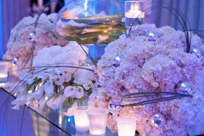 The decor had a winter theme with elegant white floral arrangements.