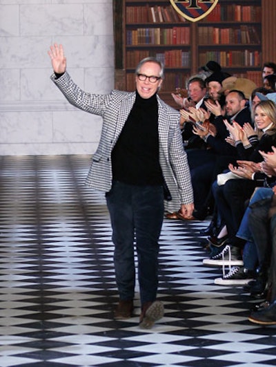 Leave it to Tommy Hilfiger to make school libraries as a backdrop to fashion seem cool. Matching the designer's preppy looks on the catwalk was a set inside the Park Avenue Armory that included trompe l’oeil wallpaper printed with books and branded banners that looked like school crests.