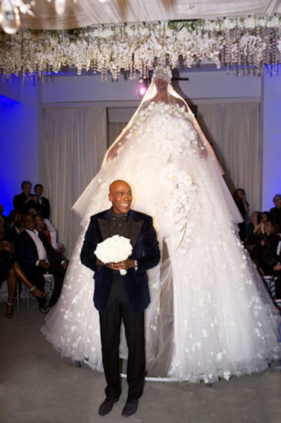 Bailey made his grand entrance as a 12-foot-tall sculpture of a wedding gown, custom-designed by Reem Acra, floated down the aisle. While it appeared that Bailey himself was wearing the gown, it was actually a body double—a fact revealed to guests when Bailey himself popped out from underneath the giant, frothy skirt.