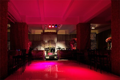 The reception room was awash in pink lighting and the dance floor displayed images of orchids, echoing the floral arrangements.