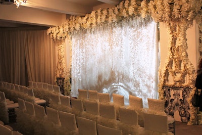 Chairs surrounded the central all-white ceremony area on three sides. Black-and-white garden images were projected onto white draping that hid the altar from view as guests arrived. As the clock struck midnight, Blackmann kicked things off by singing “You Make Me Feel So Young.'