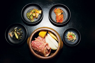 Grill-ready clay pot kalbi, with marinated beef, soybean paste, fresh garlic, red leaf lettuce, vegetables, and kimchi, by Miss Korea Barbecue in New York