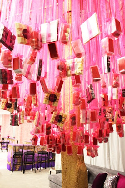 A gold-painted tree stood at the entrance to the reception space, offering guests boxes of gourmet chocolate strung from pink ribbons.