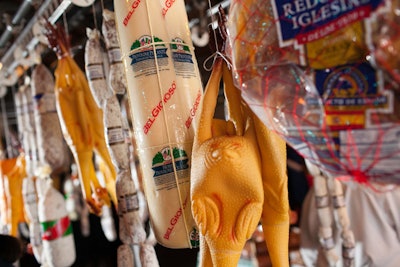 On a rotating dry-cleaning rack, hangers held meats, cheeses, and flat breads—as well as rubber chickens.