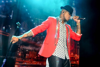 Against a cityscape backdrop, singer Ne-Yo took to the stage for a surprise performance halfway through the party.