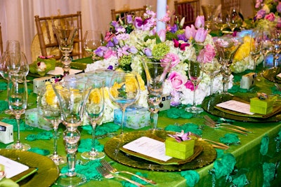 Something Different Party Rental's green Pebble Glass chargers and Murano glasses adorned the spring tabletop. Wedding Paper Divas provided the coordinated menu cards.