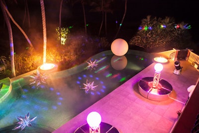 Futuristic lounge furniture set the tone for the champagne and hors d'oeuvres reception, including a silver circular bench with a truss topped with glowing orbs rising from the middle. Guests could take turns at a powerful telescope with an astronomer providing guidance.