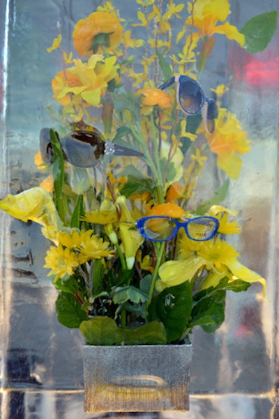 Flowers and glasses encased in blocks of ice made for striking arrangements on bar tops.