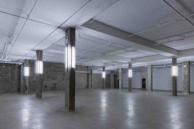 A raw concrete wall gives the vast room some edge