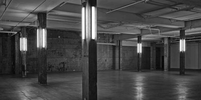 Clean white lines contrast with textured walls, making lighting interesting