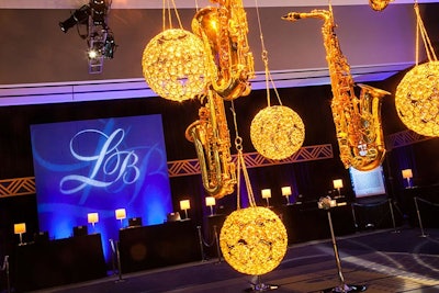 A decor piece of saxophones and crystal orbs hung from a light in the center of the check-in area.