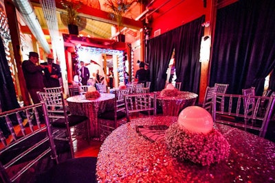 In the lounge area, café tables with sequined linens were topped with globes and rings of baby's breath. At the tables, guests sat to have snacks prepared by chef Domenic Chiaromonte of C2 Catering Couture. The menu included pulled-pork 'cigars,' 'moneybag' ravioli, and 'moonshine chowder.'