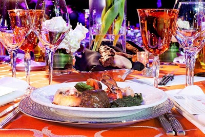 For dinner, Centerplate served filet of beef paired with a lobster tail, polenta, spinach, and a malice carrot, asparagus, and red pepper bundle.