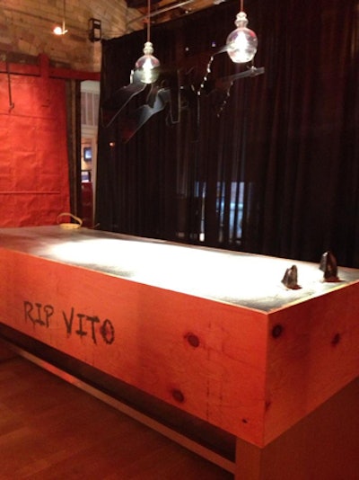 Near the lineup, Chicago-style pizza was served on a table that had a faux cement top with shoe tips sticking out of it. The 'encased body' was another cheeky nod to the gangster lifestyle.