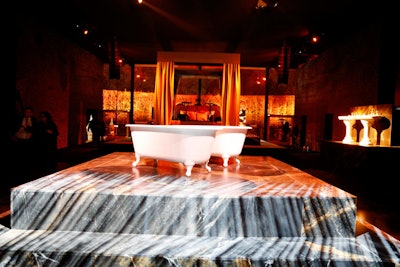 Guests were seated throughout the venue, which was elaborately decorated to resemble a posh apartment. While some sat adjacent to a bathtub in a marble-looking bathroom (pictured), others lounged in the master bedroom.