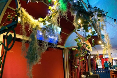 Merchandise stalls were disguised with burlap, as well as Spanish moss and ivy. A mix of green and blue gobos were also used to complement the decor and bring the transformation to life.