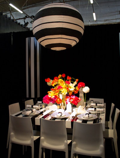 Another trend spotted on the Diffa floor: black-and-white stripes. The Architectural Digest table featured the striking pattern on the china, the surrounding columns, a giant paper lantern, and the table itself. A centerpiece of brightly hued anemones and poppies popped against the stark palette.