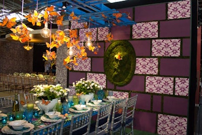 The Eric Warner for Aesthete table, hosted by Tracy Reese, also jumped on the spring bandwagon, featuring faux butterflies and lightbulbs hanging from an overhead trellis, as well as a wall displaying patterned fabric panels and a silhouette made entirely out of moss.