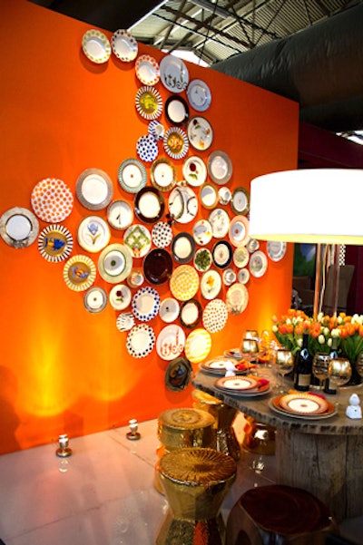 Orange was popular color choice this year. Marc Blackwell painted an entire wall in the hue, covering it with an eclectic collection of china. Nearby, a giant tree-stump table displayed a oversize drum shade lamp as a centerpiece, surrounded by orange and white tulips. A charming touch: porcelain birds at each place setting made chirping noises.