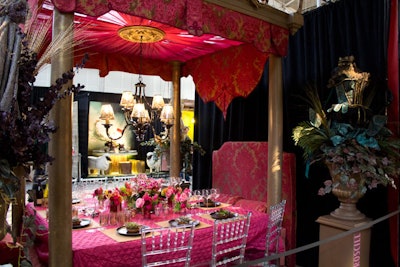 Resembling a canopy bed, Croscill's table was covered in a bright pink quilted tablecloth and surrounded by clear Chiavari chairs.