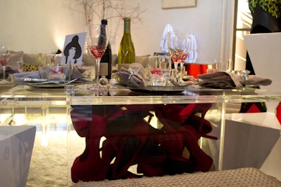 Titled 'Dinner in the Boudoir de Madame,' the installation created by Charlene Bank Keogh, Adeline Olmer, and Blane Charles was designed to look like the apartment of an eccentric socialite. Housed inside the base of one of the Lucite coffee tables were several pairs of red high heels.